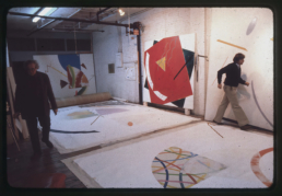 Curator Gene Baro selects Paintings with artist William Conlon & asst Peter Stevens for Museum of Art - Carnegie Institute exhibition. Broome Street Studio, 1981