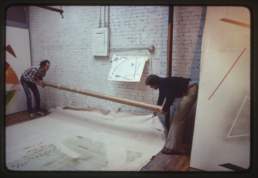 asst. Peter Stevens helping artist William Conlon select Paintings for Museum of Art - Carnegie Institute exhibition. Broome Street Studio, 1981